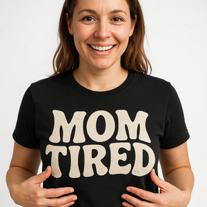Close-up of the "Mom Tired" beige print on a premium Bella+Canvas black cute mom life shirts
