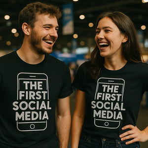 Person wearing the black smartphone t shirt graphic tee - "The First Social Media" design