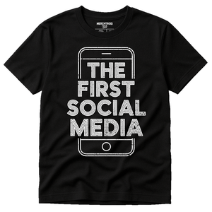 Black Smartphone T Shirt - "The First Social Media" graphic tee with white print, flat lay product photo
