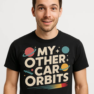 Close-up of the "My Other Car Orbits" beige print on a premium Bella+Canvas black space science shirts