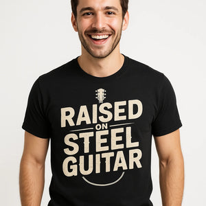 Close-up of the "Raised on Steel Guitar" beige print on a premium Bella+Canvas black country music shirts