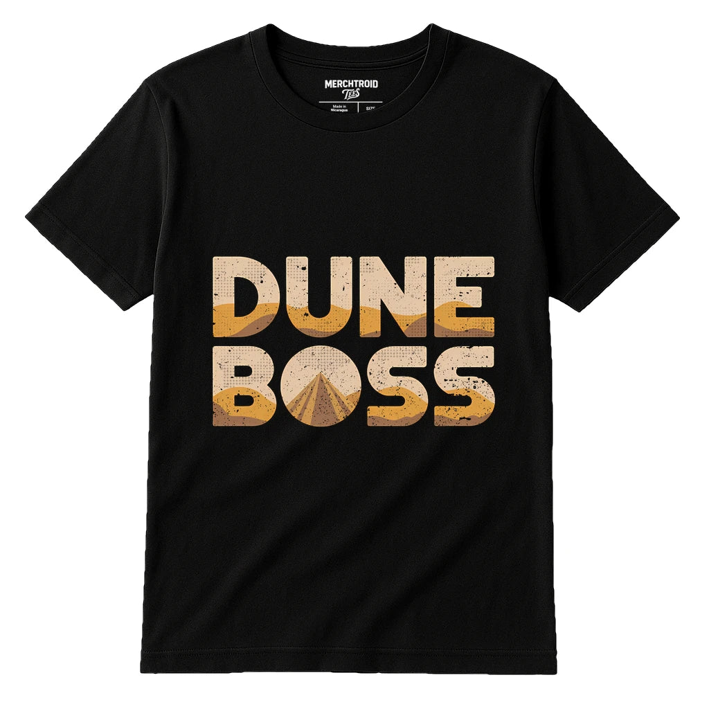 A black t-shirt with large, bold text that reads "DUNE BOSS" in a sandy, textured style that gives a desert-like appearance. There is no person in the image.