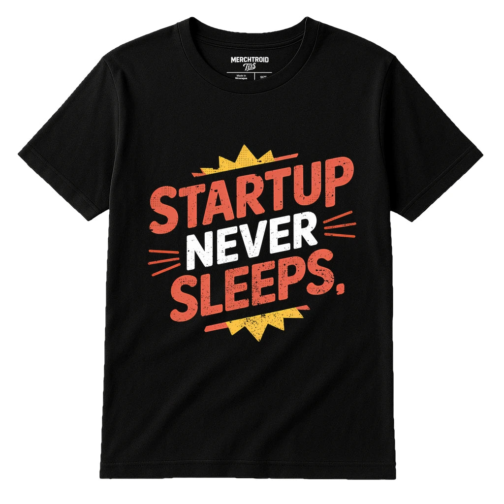 A black t-shirt with bold, colorful text printed on it. The words "STARTUP NEVER SLEEPS," are written in red and white with decorative elements like lines and a yellow starburst.
