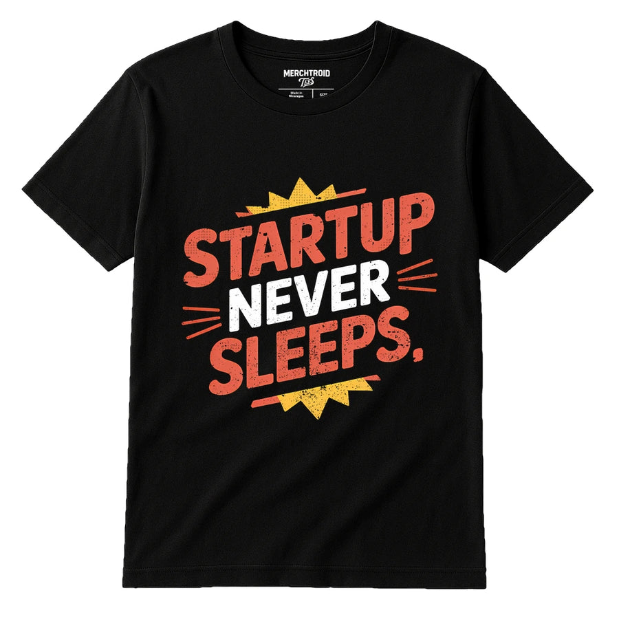 A black t-shirt with bold, colorful text printed on it. The words "STARTUP NEVER SLEEPS," are written in red and white with decorative elements like lines and a yellow starburst.