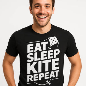Close-up of the "Eat Sleep Kite Repeat" white print on a premium Bella+Canvas black kite flying t shirt