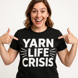 Close-up of the "Yarn Life Crisis" white print on a premium Bella+Canvas black knitting t shirt