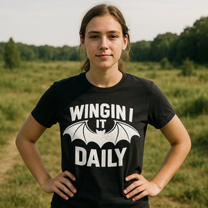 Lifestyle shot of the "Wingin It Daily" black batwing tshirt in a real-world setting
