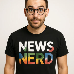 Close-up of the "News Nerd" gray print on a premium Bella+Canvas black journalist t shirt