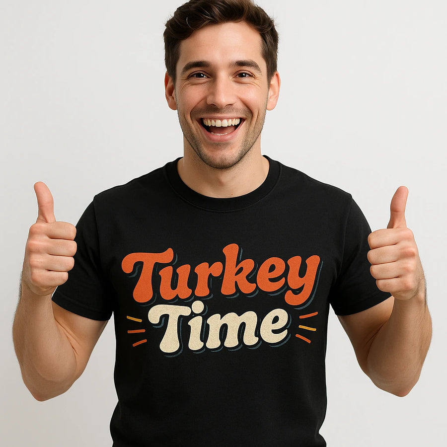 A person is smiling broadly and giving two thumbs up, wearing a black T-shirt with the phrase "Turkey Time" in large, colorful letters. The background is plain white.