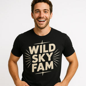 Close-up of the "Wild Sky Fam" beige print on a premium Bella+Canvas black storms t shirt