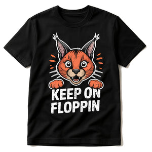 Black Caracal T Shirt - "Keep on Floppin" graphic tee with orange print, flat lay product photo