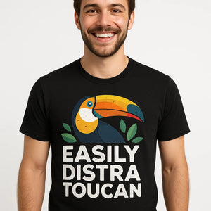 Close-up of the "Easily Distra Toucan" white print on a premium Bella+Canvas black toucan t shirt