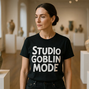 Lifestyle shot of the "Studio Goblin Mode" black online ceramics tee in a real-world setting