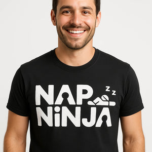Close-up of the "Nap Ninja" white print on a premium Bella+Canvas black relaxing t shirt