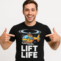 A smiling person with short hair wearing a black T-shirt featuring a colorful illustration of a helicopter above the text 