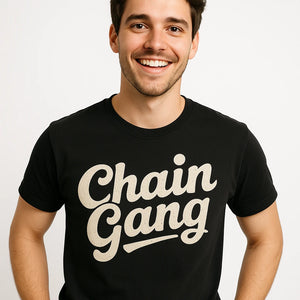 Close-up of the "Chain Gang" cream print on a premium Bella+Canvas black jewelry making t shirt