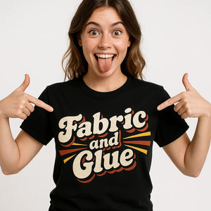 Close-up of the "Fabric and Glue" beige print on a premium Bella+Canvas black cosplayers t shirt