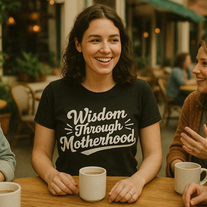 Lifestyle shot of the "Wisdom Through Motherhood" black mama life t shirt in a real-world setting