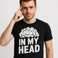 A person wearing a black t-shirt with a white graphic of a brain and the text 