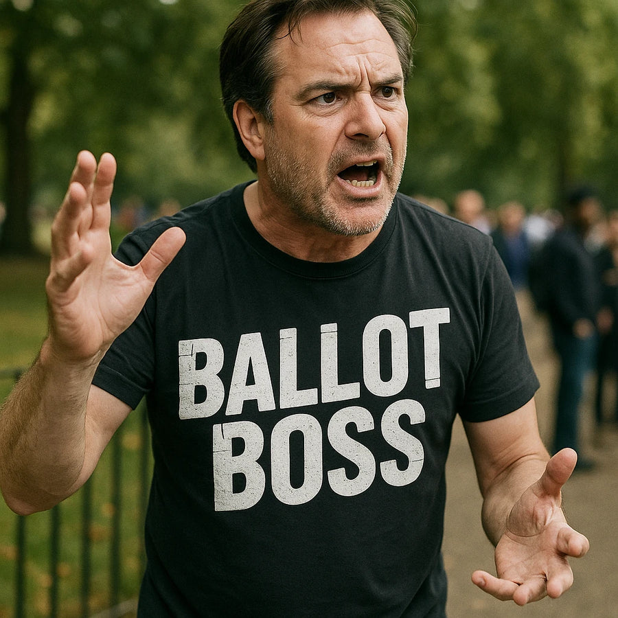 A person wearing a black t-shirt with the printed text "BALLOT BOSS" gestures expressively with one hand raised. The individual appears to be speaking passionately, outdoors, with blurred greenery and other people in the background.