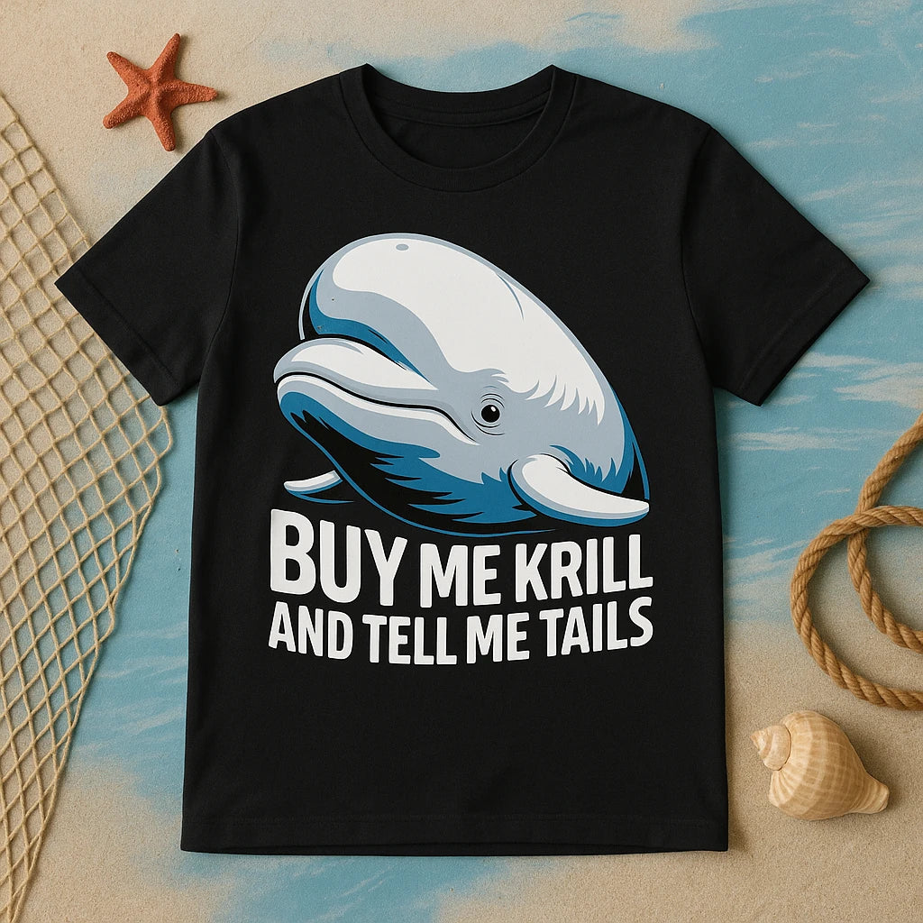 A black T-shirt featuring an illustration of a smiling whale above the text. The shirt is laid out on a surface with a nautical theme, including a starfish, a fishing net, a coiled rope, and a seashell.