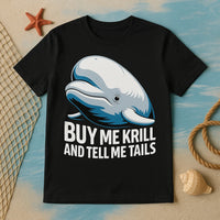 A black T-shirt featuring an illustration of a smiling whale above the text. The shirt is laid out on a surface with a nautical theme, including a starfish, a fishing net, a coiled rope, and a seashell.