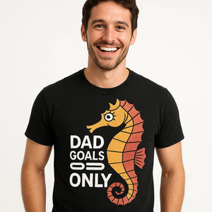 Close-up of the "Dad Goals Only" orange print on a premium Bella+Canvas black seahorse t shirt
