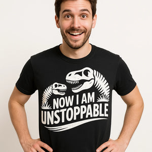 Close-up of the "Now I Am Unstoppable" white print on a premium Bella+Canvas black paleontology shirts