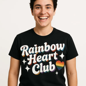 Close-up of the "Rainbow Heart Club" white print on a premium Bella+Canvas black lgbtq pride t shirt
