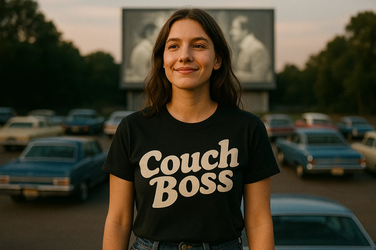 Lifestyle shot of the "Couch Boss" black graphic tee in a real-world setting