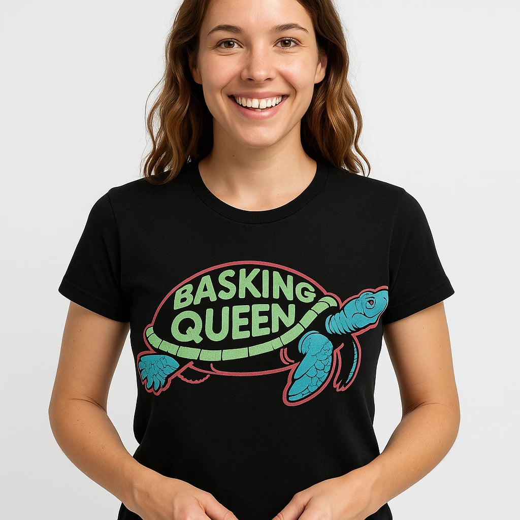 Close-up of the "Basking Queen" gray print on a premium Bella+Canvas black turtle tee
