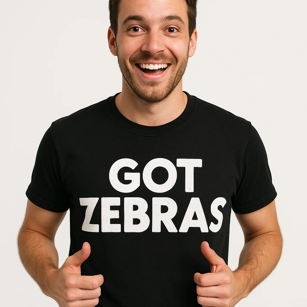 Close-up of the "Got Zebras" white print on a premium Bella+Canvas black zookeeper shirts