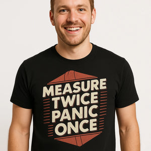 Close-up of the "Measure Twice Panic Once" tan print on a premium Bella+Canvas black architect t shirt