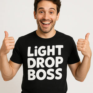 Close-up of the "Light Drop Boss" white print on a premium Bella+Canvas black men's new years eve shirts