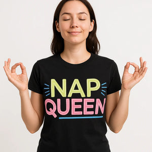 Close-up of the "Nap Queen" tan print on a premium Bella+Canvas black relaxing t shirt