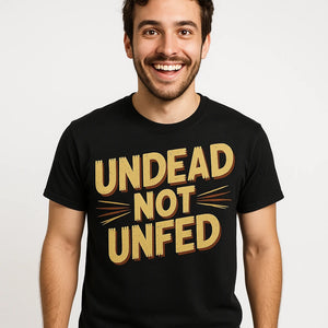 Close-up of the "Undead Not Unfed" tan print on a premium Bella+Canvas black zombie t shirt