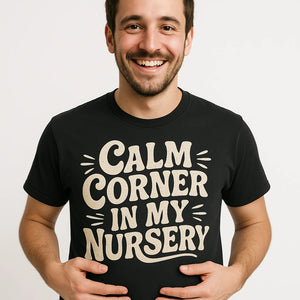 Close-up of the "Calm Corner in My Nursery" beige print on a premium Bella+Canvas black new parents shirts