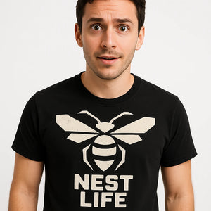 Close-up of the "Nest Life" cream print on a premium Bella+Canvas black hornets tee shirts
