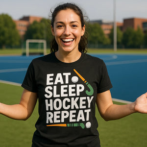 Lifestyle shot of the "Eat Sleep Hockey Repeat" black field hockey tee shirts in a real-world setting