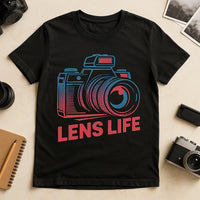 A black T-shirt featuring a colorful graphic of a camera above the text 