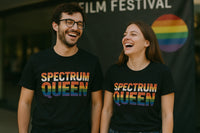 Two people are smiling and laughing while standing in front of a banner that reads 