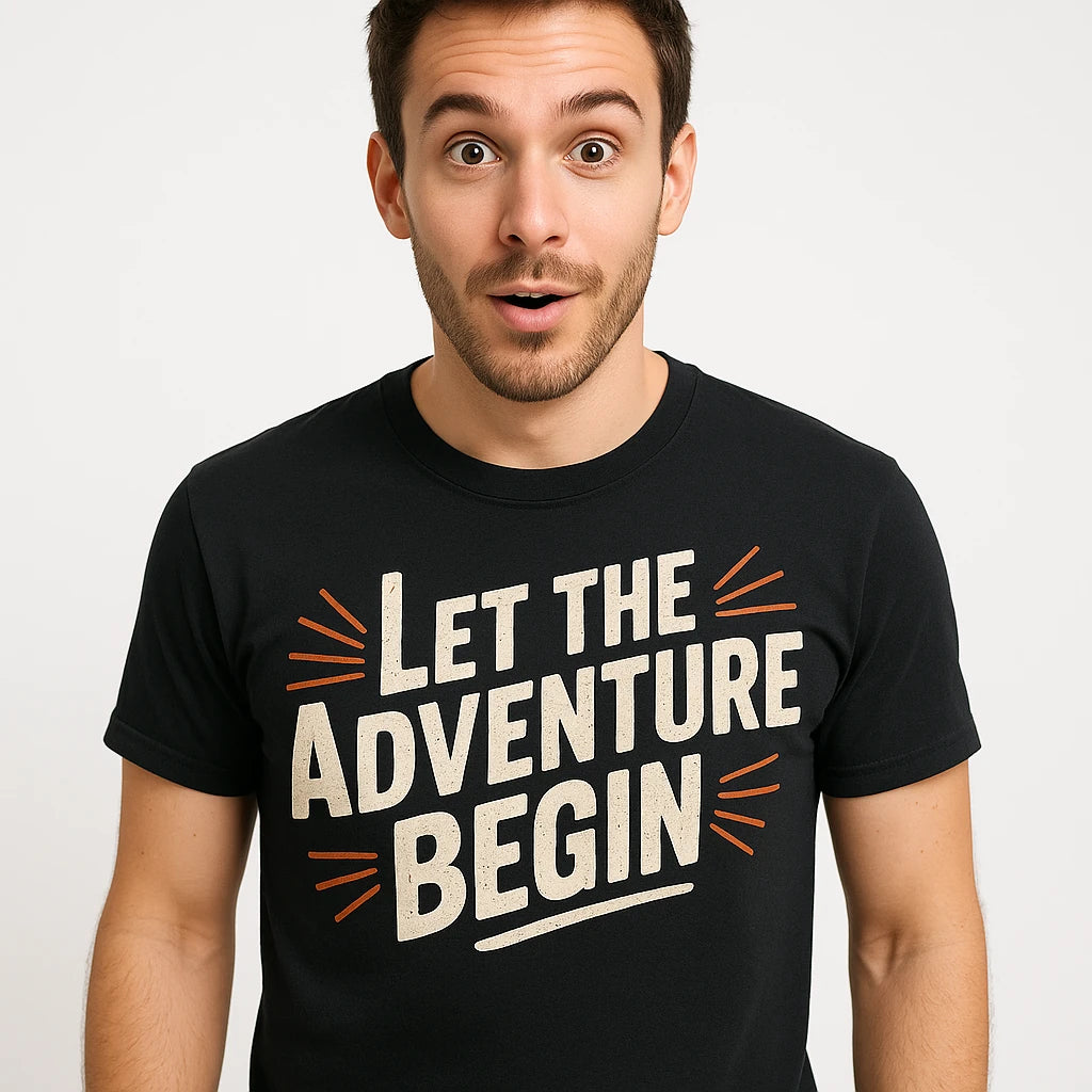 Close-up of the "Let the Adventure Begin" cream print on a premium Bella+Canvas black adventure travel shirts
