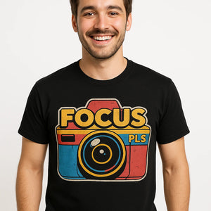 Close-up of the "Focus Pls" orange print on a premium Bella+Canvas black photography on t shirts