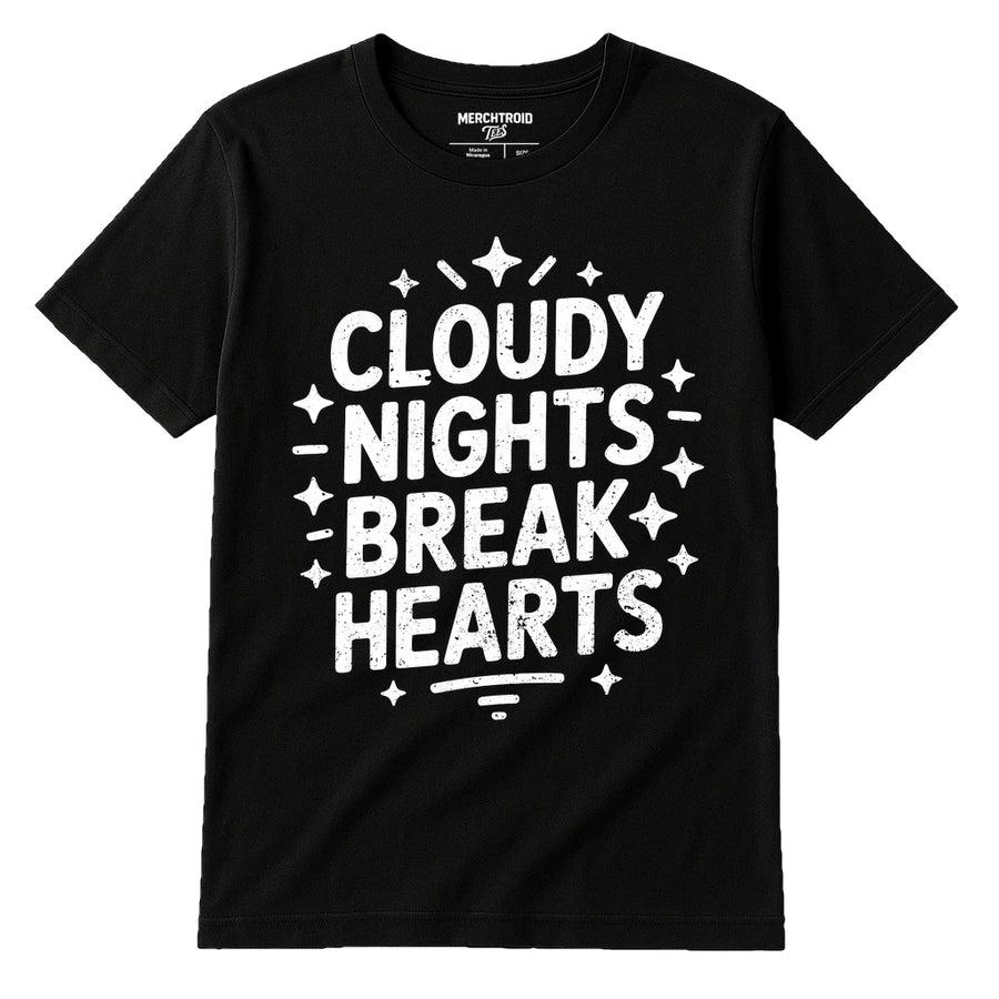 A black t-shirt with bold white text that reads "CLOUDY NIGHTS BREAK HEARTS" surrounded by star-like designs. The label at the neck reads "MERCHTROID."