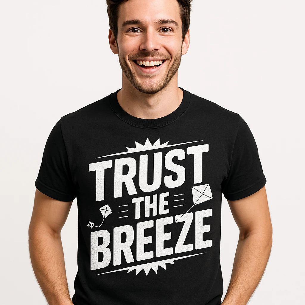 Close-up of the "Trust the Breeze" white print on a premium Bella+Canvas black kite flying t shirt