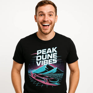 Close-up of the "Peak Dune Vibes" gray print on a premium Bella+Canvas black sandboarding shirts