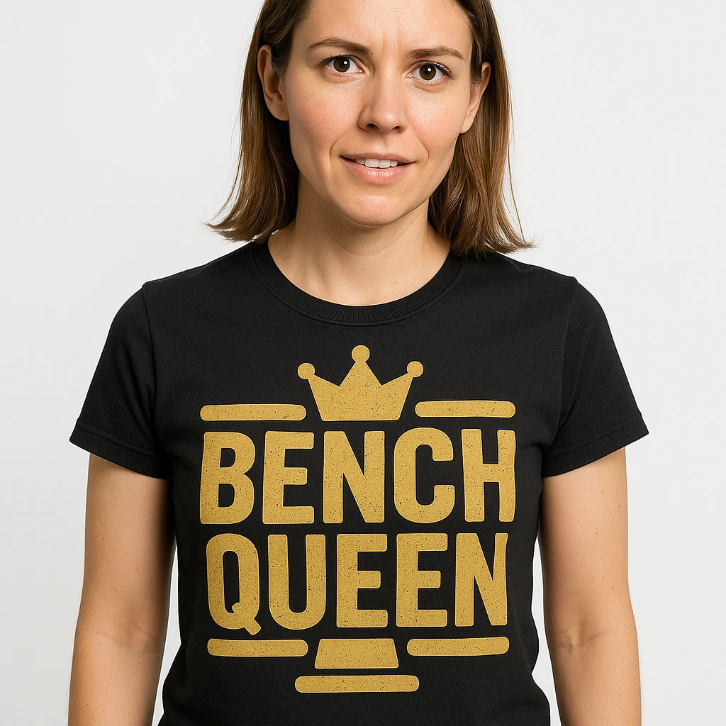 Close-up of the "Bench Queen" gold print on a premium Bella+Canvas black judge t shirt