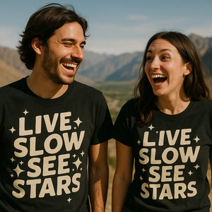 Person wearing the black stargazing t shirt graphic tee - "Live Slow See Stars" design