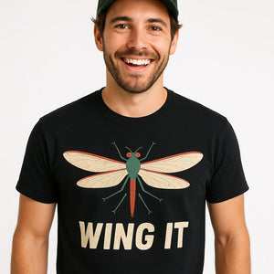 Close-up of the "Wing It" beige print on a premium Bella+Canvas black mayfly t shirt