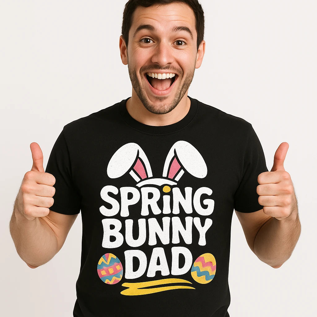 A smiling person wearing a black t-shirt that says "SPRING BUNNY DAD" with bunny ears and colorful eggs graphic. The person is giving two thumbs up.